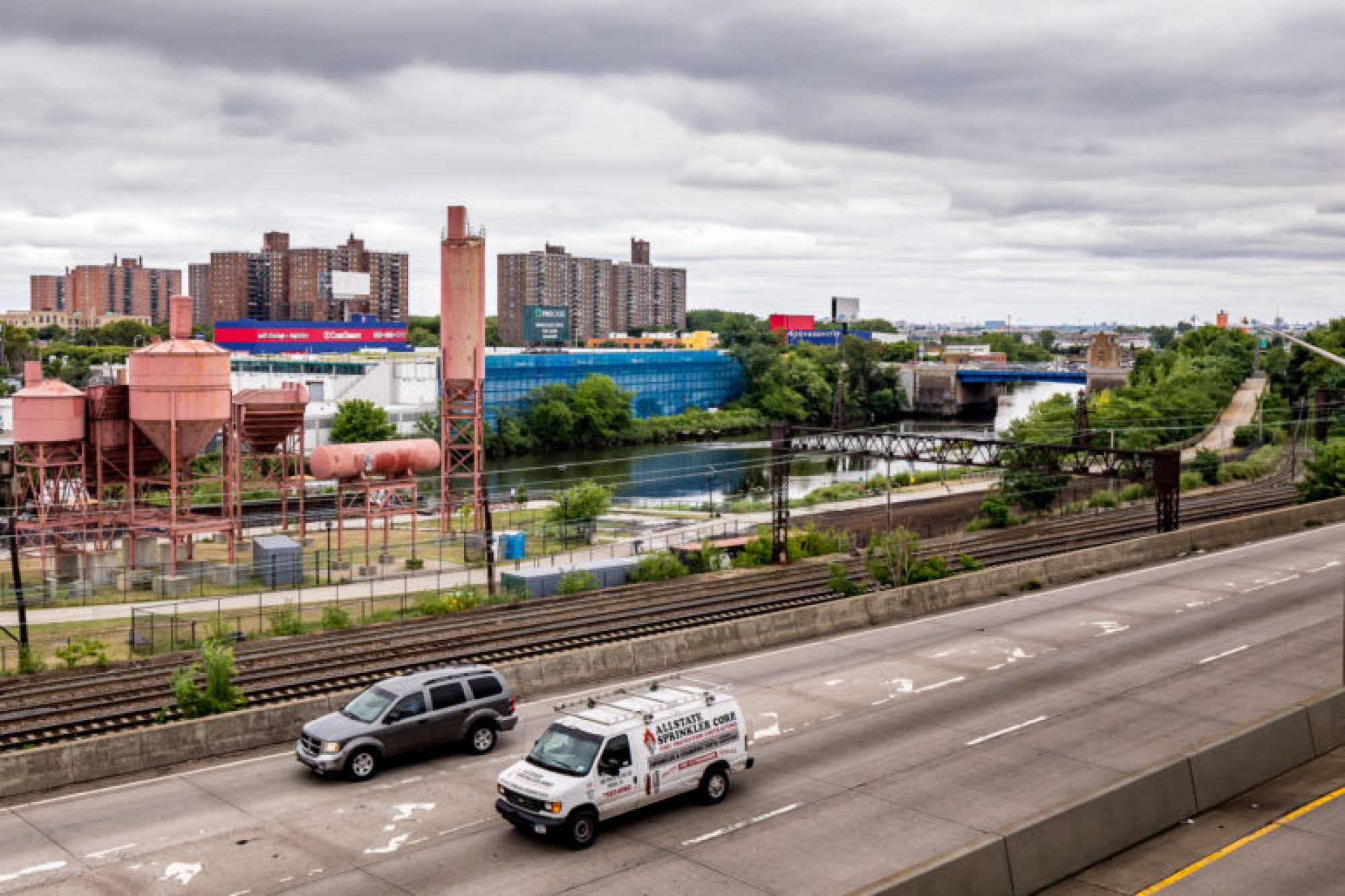 Monday July 24: Looking South East from From the Whitlock Avenue 6 train station in the Bronx at the Sheridan Expressway, freight train tracks, Concrete Plant Park, Bronx River, warehouses and Lafayette Boynton Housing Corporation to name a few.